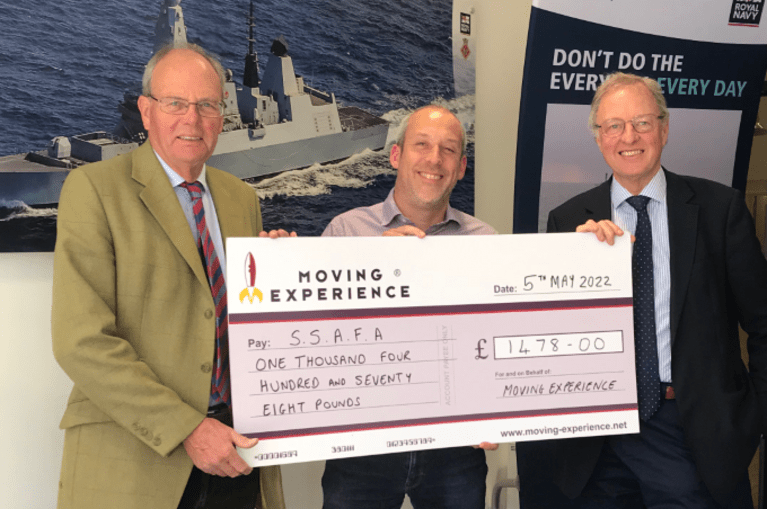 Moving Experience handing over cheque after raising money for armed forces charity